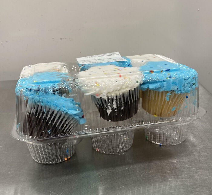 Cupcakes in plastic packaging with squashed blue and white frosting, illustrating customer cluelessness.