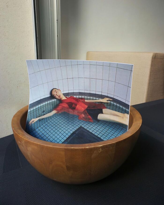 Astonishing illusion by Dudi Ben Simon: a man appears to float in a pool, printed on paper inside a wooden bowl.