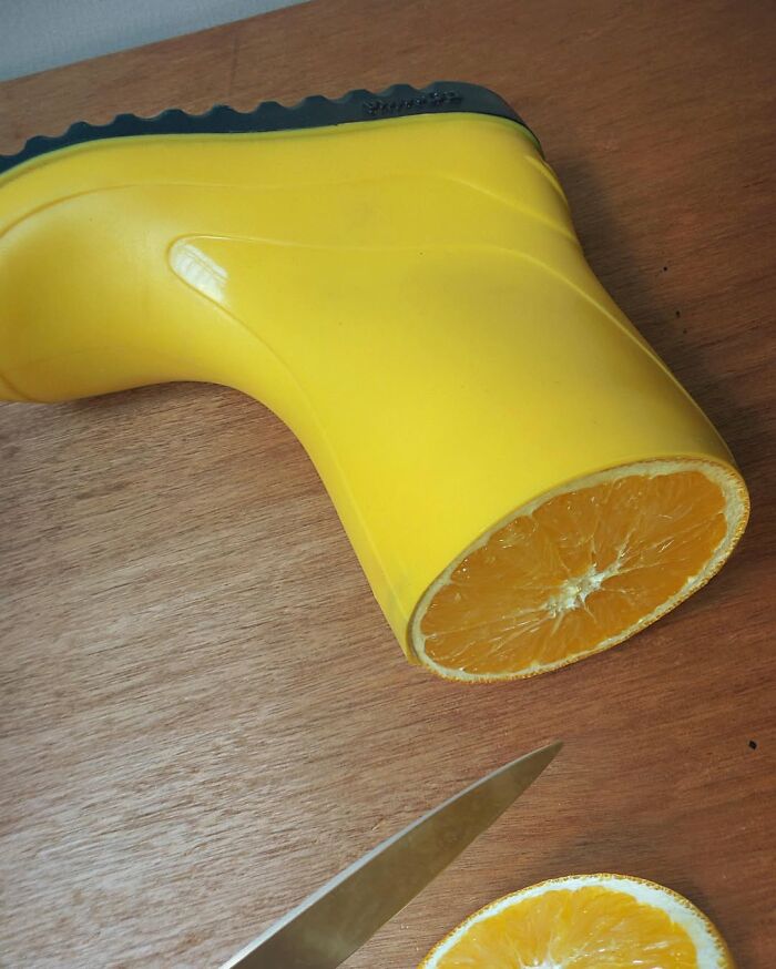 Yellow boot fused with an orange, showcasing art of illusion by Dudi Ben Simon.