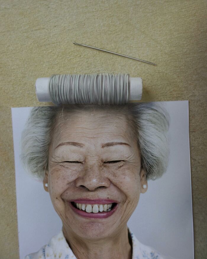 Illusion art by Dudi Ben Simon, showing a smiling face with thread spool and needle in creative fusion.