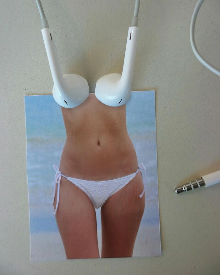 Headphones creatively placed to appear as a bikini top in an art illusion by Dudi Ben Simon.