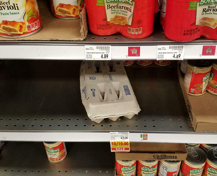 Egg carton misplaced on shelf with canned pasta, highlighting customer cluelessness in a supermarket setting.