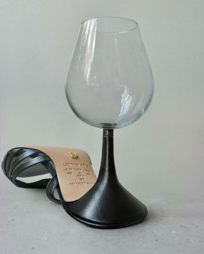 Wine glass and shoe fusion showcasing Dudi Ben Simon's illusion art creativity in a minimalist setting.