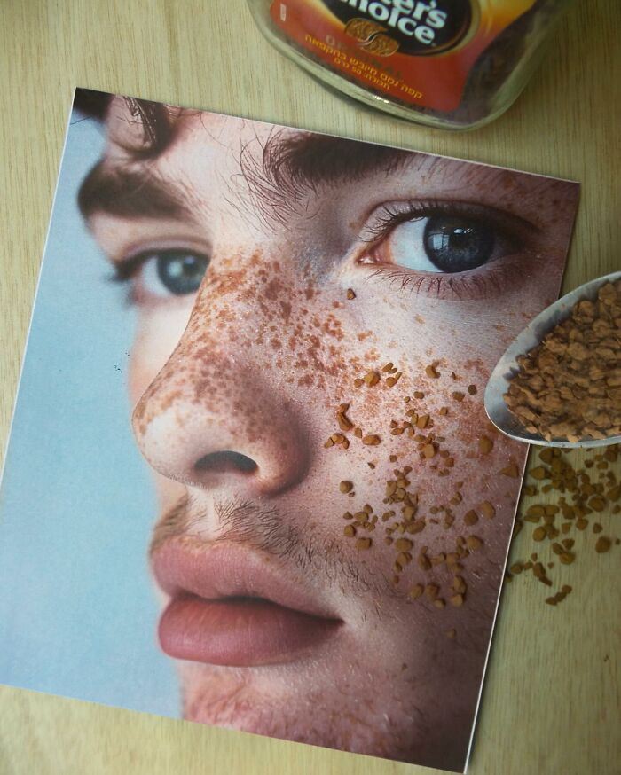 A creative illusion by Dudi Ben Simon, blending a photo of a face with grains from a spoon on a wooden surface.