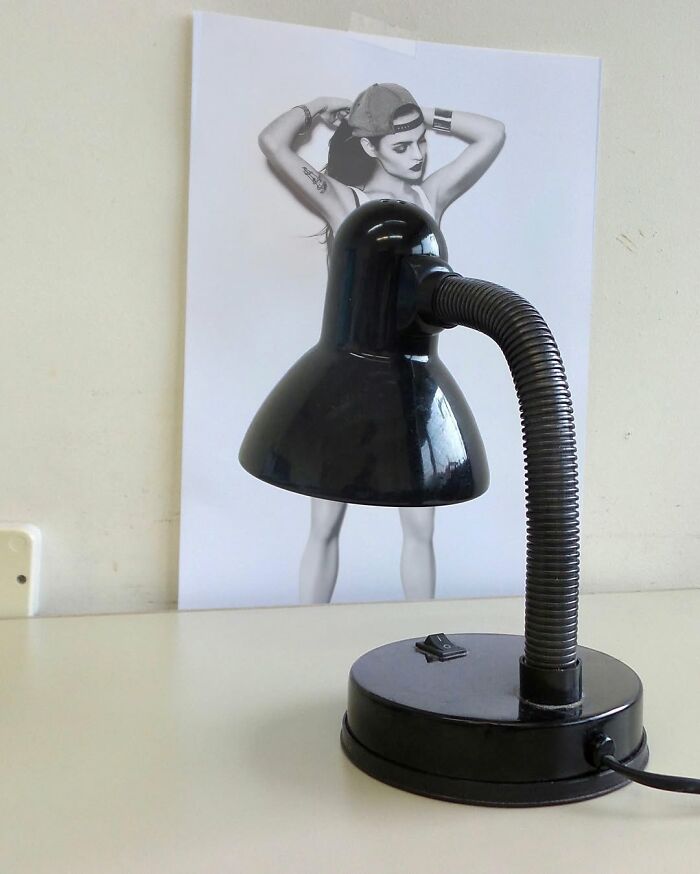 A desk lamp cleverly aligned with a photo creates an illusion of a dress, showcasing Dudi Ben Simon's art fusions.