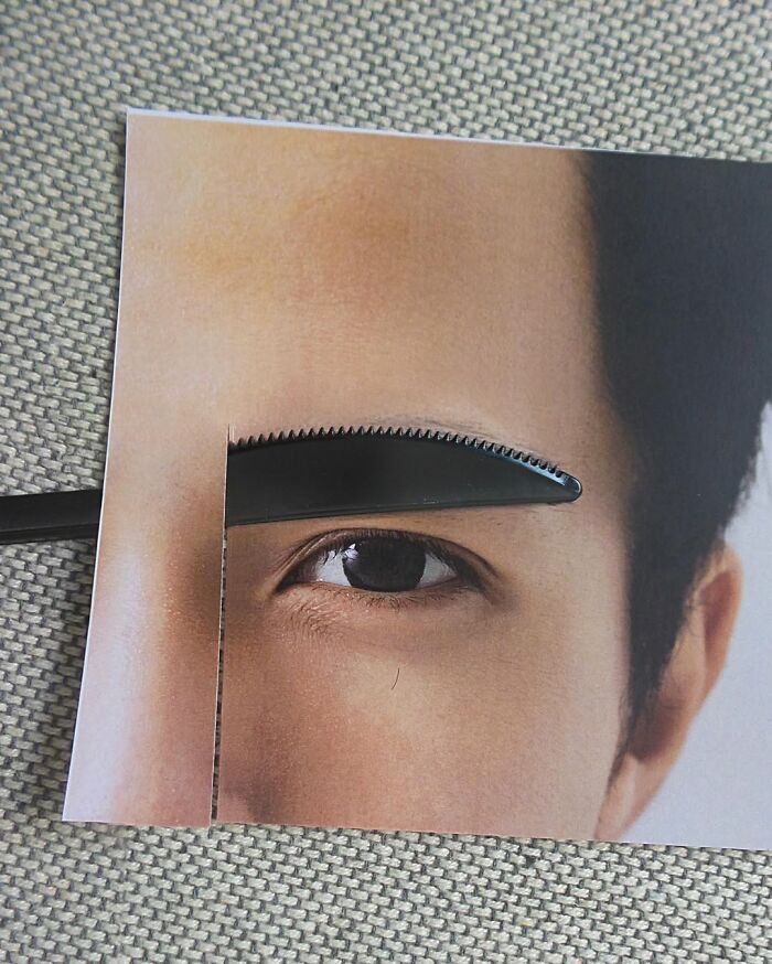 Illusion art by Dudi Ben Simon, depicting a photo of a man's eye with a fork resembling an eyebrow.