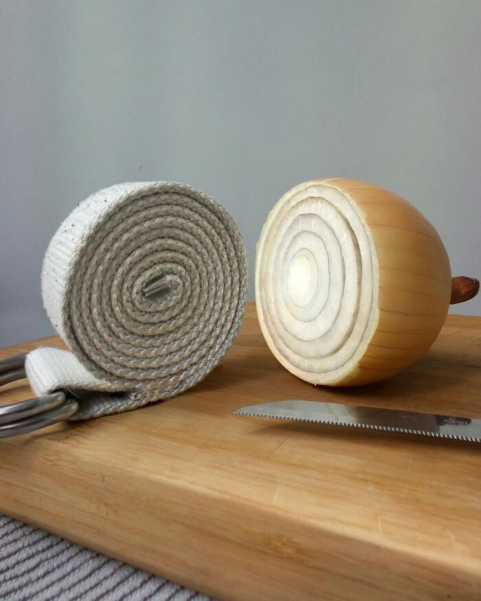 Astonishing fusion of belt and onion on a wooden board with a knife in Dudi Ben Simon creation.