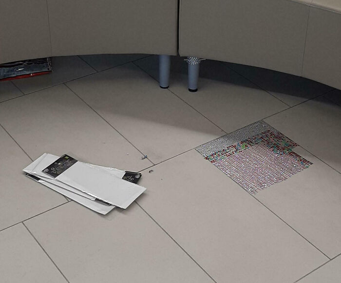 Scattered papers on a tiled floor resembling artwork—illustrating customer cluelessness.