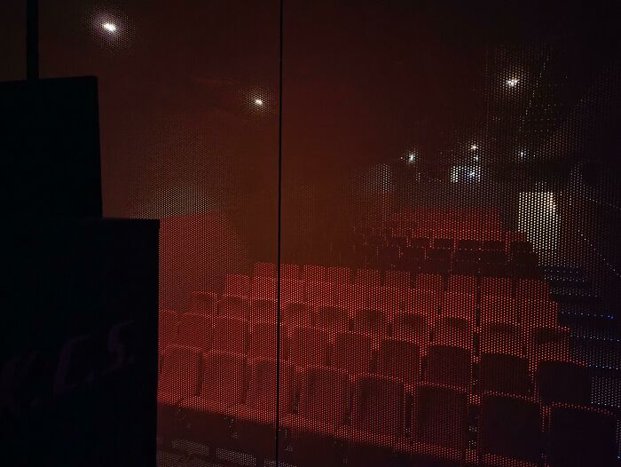 Dimly lit theater with rows of red seats, evoking an awe-inspiring atmosphere of iconic places.