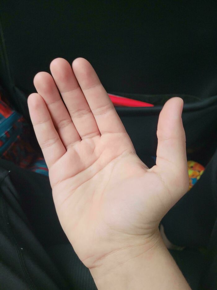 A close-up of an open hand with palm facing up, surrounded by a neutral background.