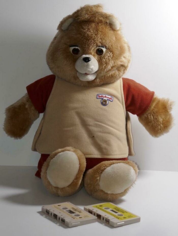 Teddy Ruxpin bear with cassette tapes, iconic 1980s toy.