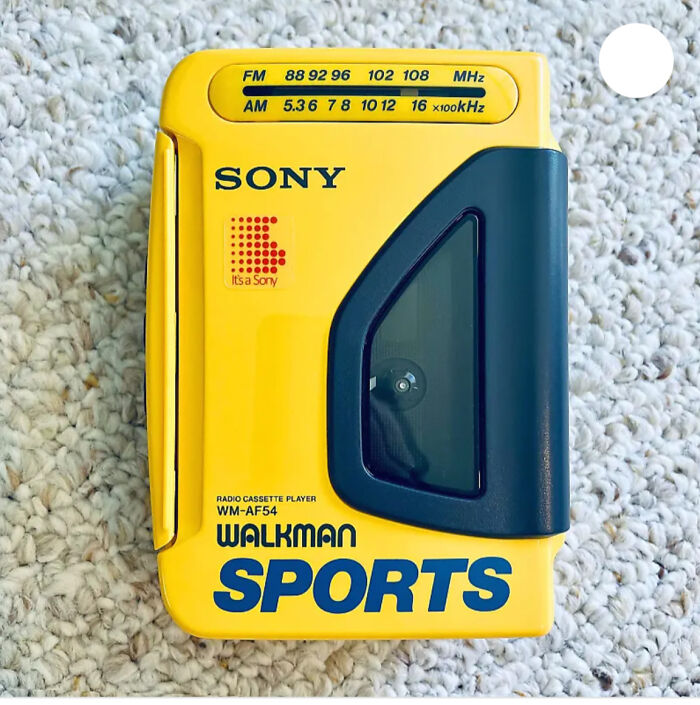 Yellow Sony Walkman SPORTS on a textured carpet, capturing the 1980s vibe.