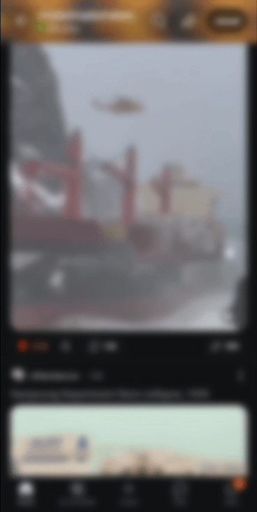 Blurry image of a foggy landscape with red structures, depicting uninteresting scenery.