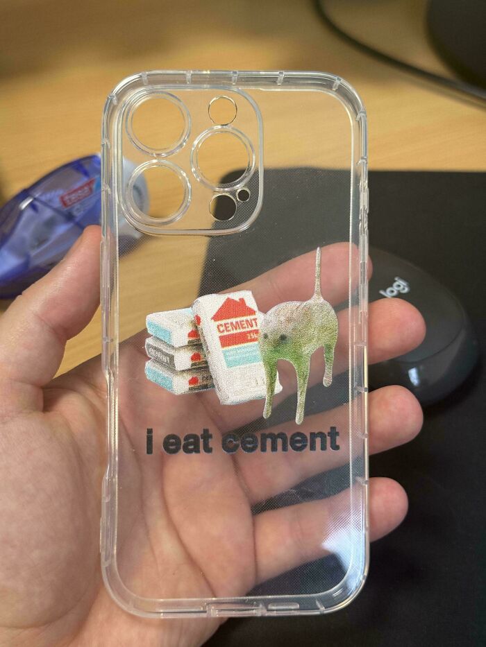 Clear phone case with a playful "I eat cement" design on a person's hand.