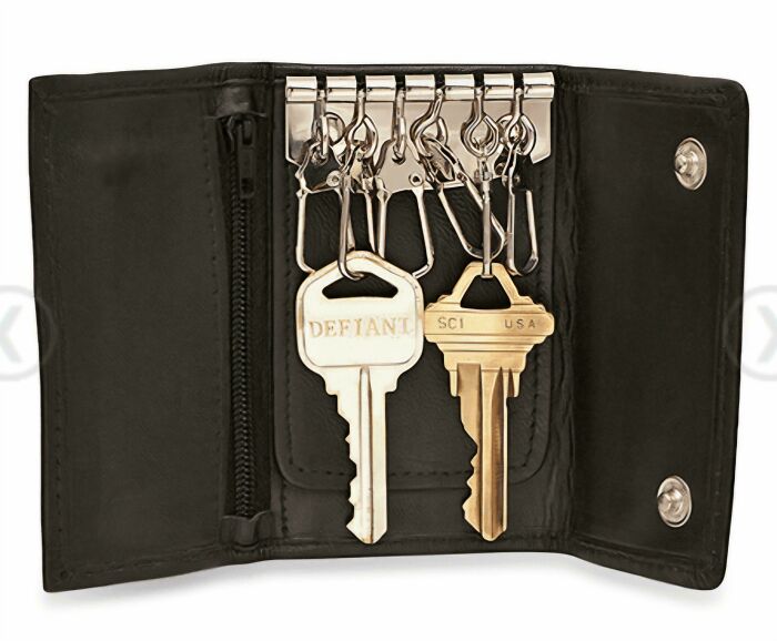 Black leather key holder wallet with metal hooks and two vintage style keys attached inside.