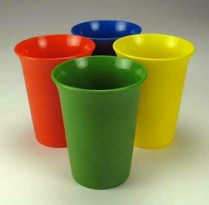 Colorful plastic cups in 1980s style, featuring vibrant red, green, yellow, and blue hues.