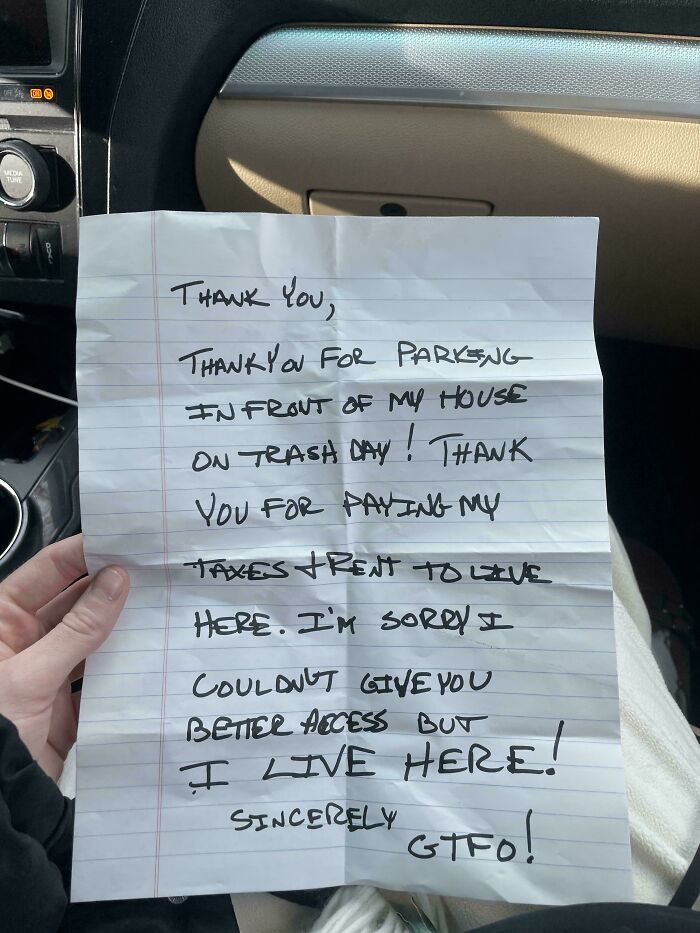 Handwritten passive-aggressive note left on a car, expressing frustration about parking on trash day.