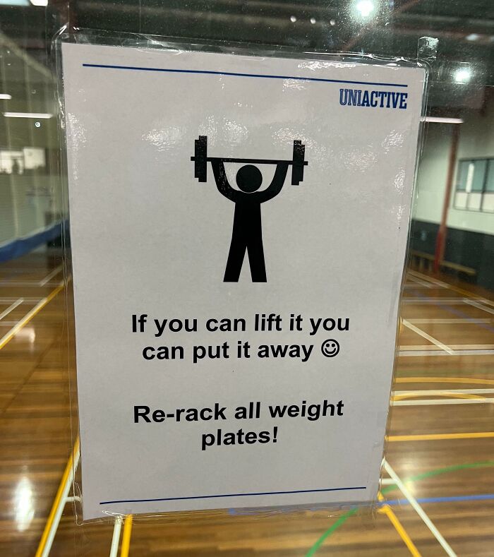 Gym sign with a passive-aggressive message to re-rack weights after use, featuring a lifting illustration.