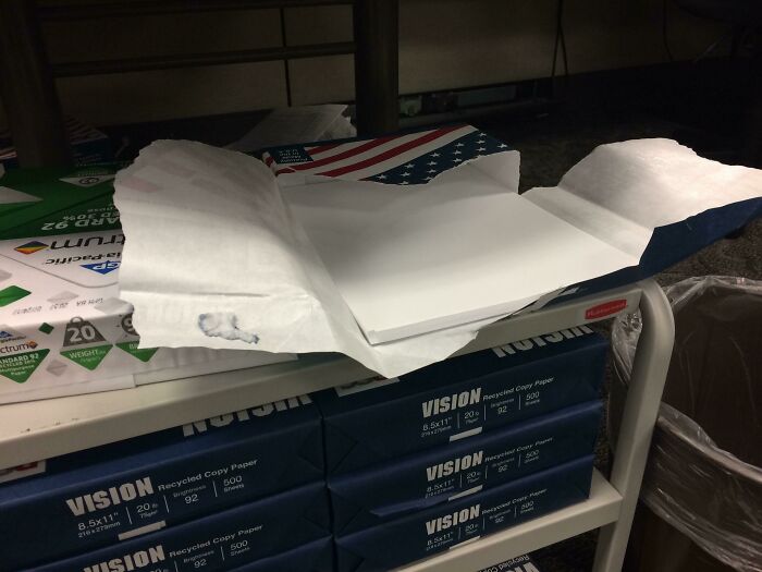 Open ream of copy paper left on a shelf, showing unorganized workplace habits by colleagues.