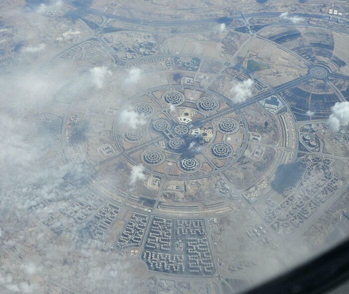 Aerial view of iconic circular urban design in Cairo, blending modern architecture with the surrounding landscape.