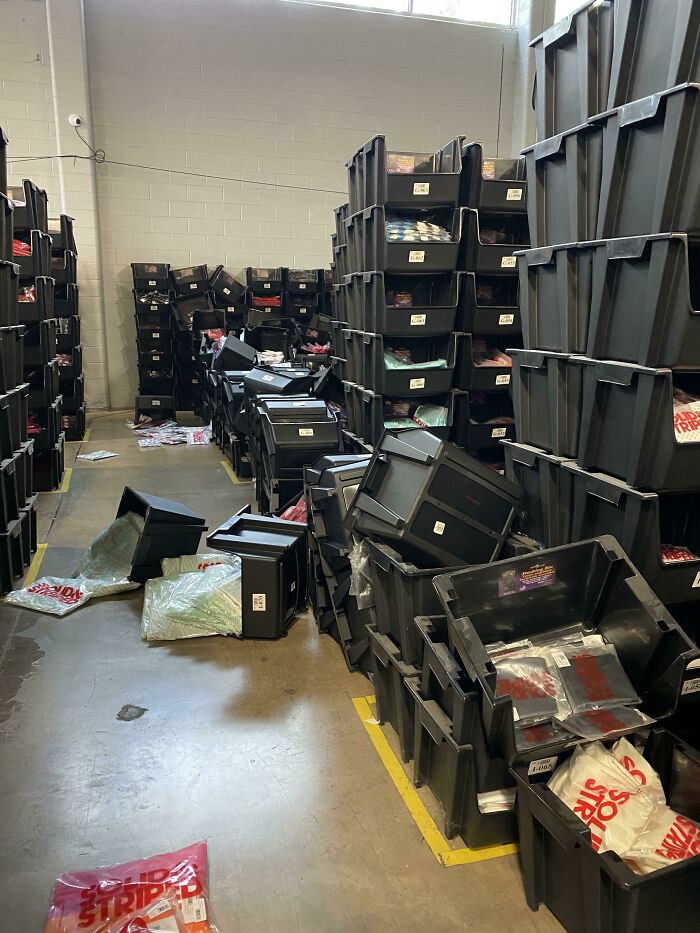 Warehouse disaster with toppled crates and scattered items, highlighting a worst day at work scenario.