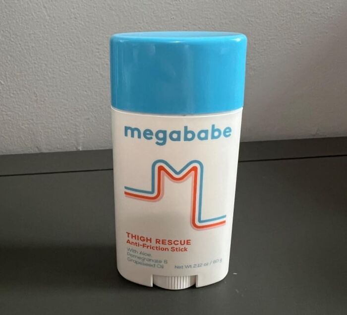 Megababe Thigh Rescue anti-friction stick with blue cap on a gray surface for spring essentials.