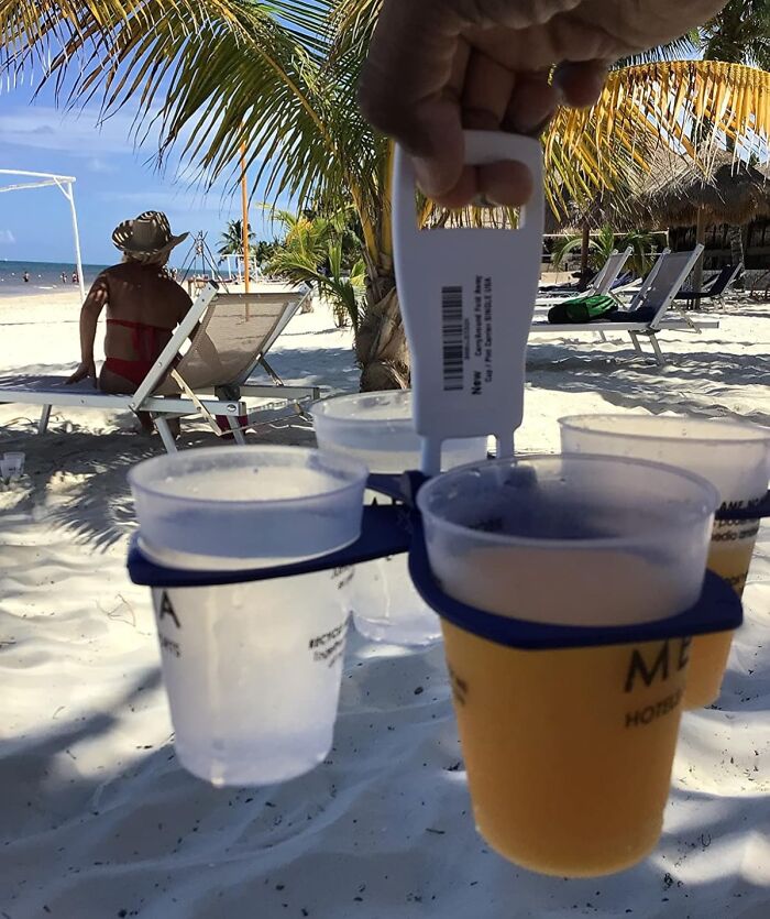 Beach scene with a drink holder carrying cups, representing essential items for spring relaxation.