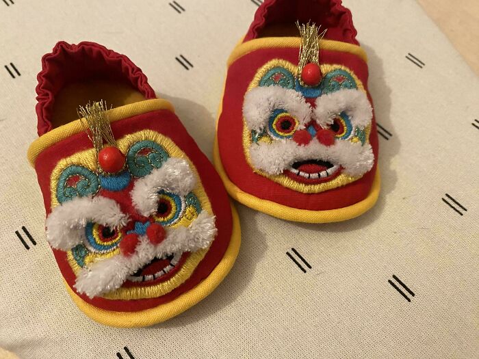 Pair of red and yellow baby shoes featuring intricate and beautiful embroidery showcasing incredible embroidery skills.