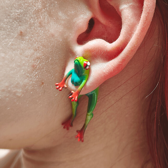 Unique DIY frog earring resembling a tree frog, attached to an ear.