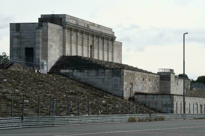 Massive stone building with steep steps and an eerie atmosphere reminiscent of supervillain headquarters architecture.