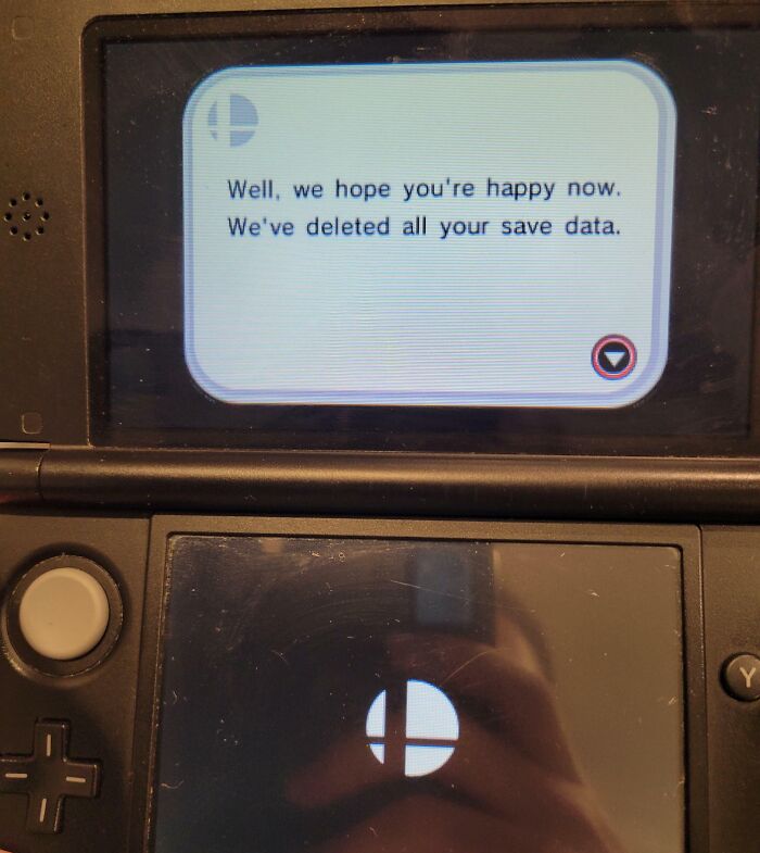 Passive-aggressive gaming message on a console, humorously stating save data deletion.