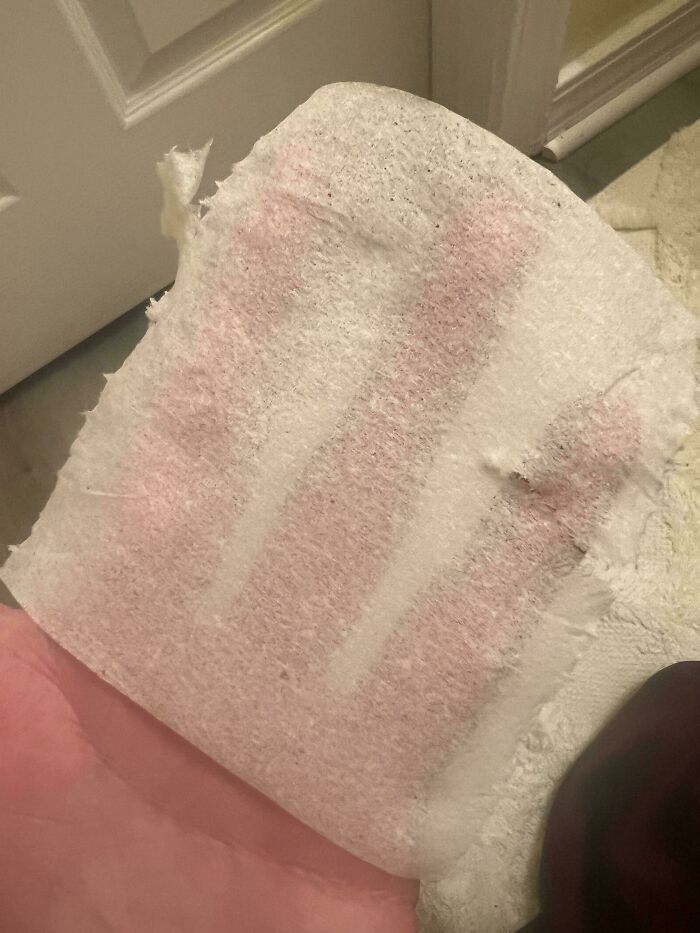 Torn toilet paper held in hand, representing in-law troubles and frustrations.