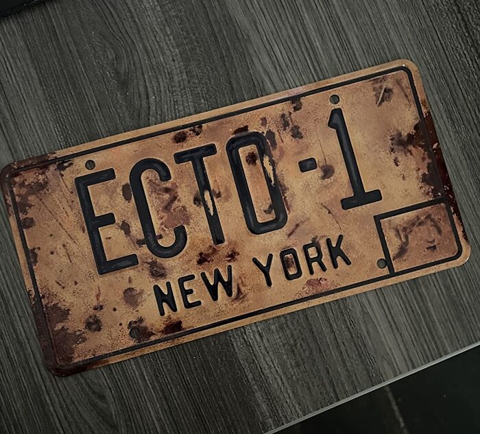 Vintage ECTO-1 New York movie prop license plate displayed on a table.