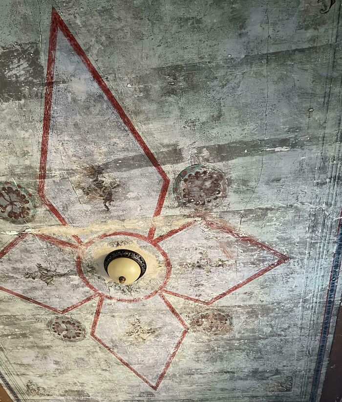 Vintage ceiling mural with geometric design discovered in an old house.