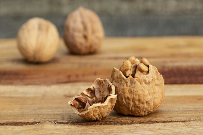 Cracked walnut on wooden table, symbolizing how life gets better with simple approaches.