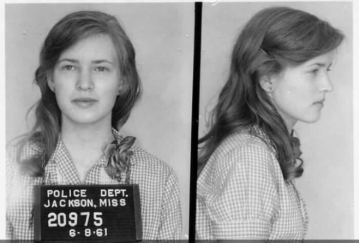 Young woman in a vintage mugshot, reflecting a seemingly ridiculous moment from the past.
