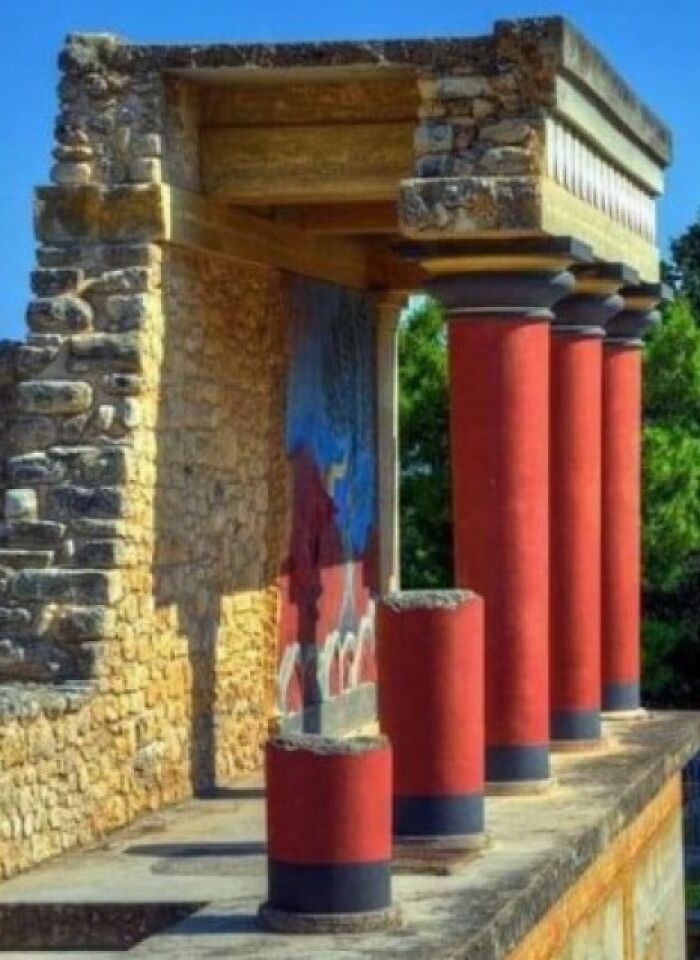 Ancient explorers' archaeological site with red columns and a mural, showcasing historic preservation.