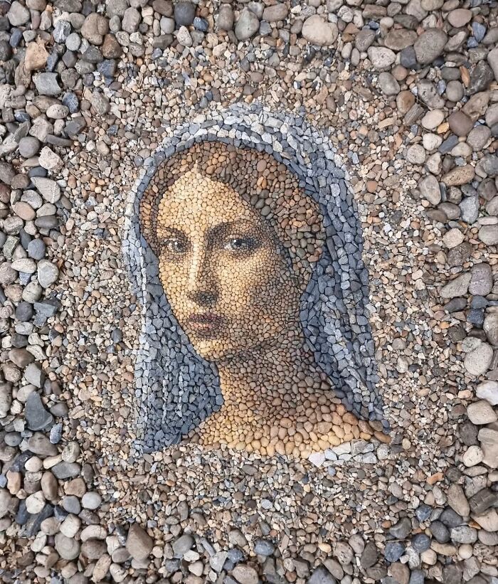 Pebble mosaic art depicting a woman's face, crafted with intricate detail using stones.
