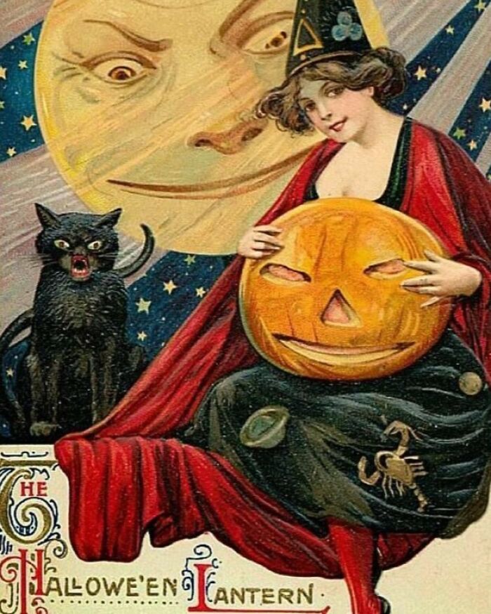 Vintage Halloween postcard showing a woman with a jack-o'-lantern and a black cat under a smiling moon.