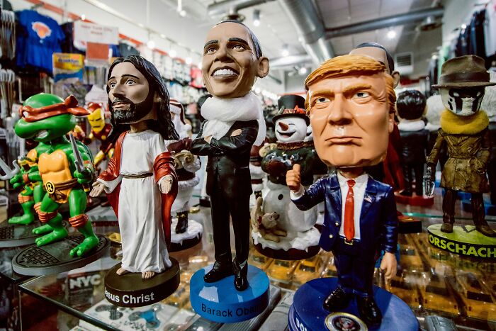 Bobblehead figures of historical turning points, featuring various famous personalities in a shop display.