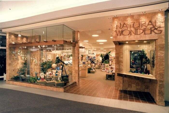 Vintage mall store with a Natural Wonders storefront, showcasing globes and natural decor.