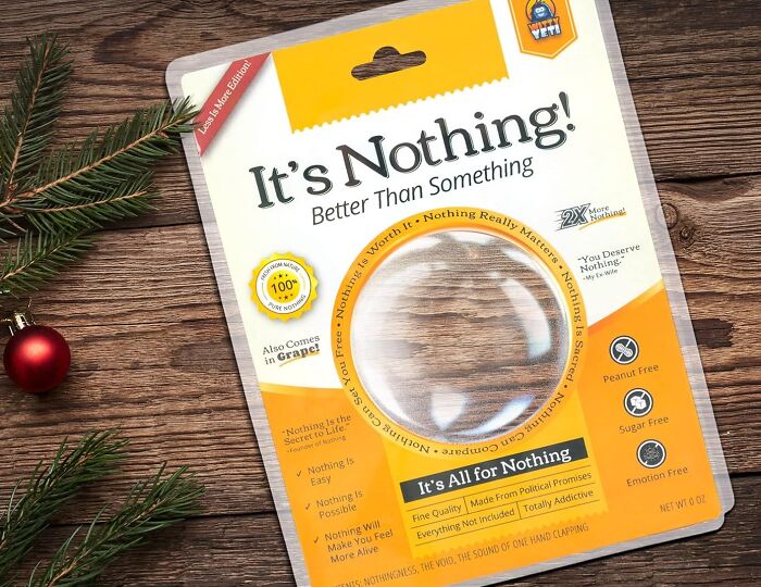 Package of "It's Nothing," a humorous gift idea for April Fools' pranks, displayed on a wooden surface with festive decor.