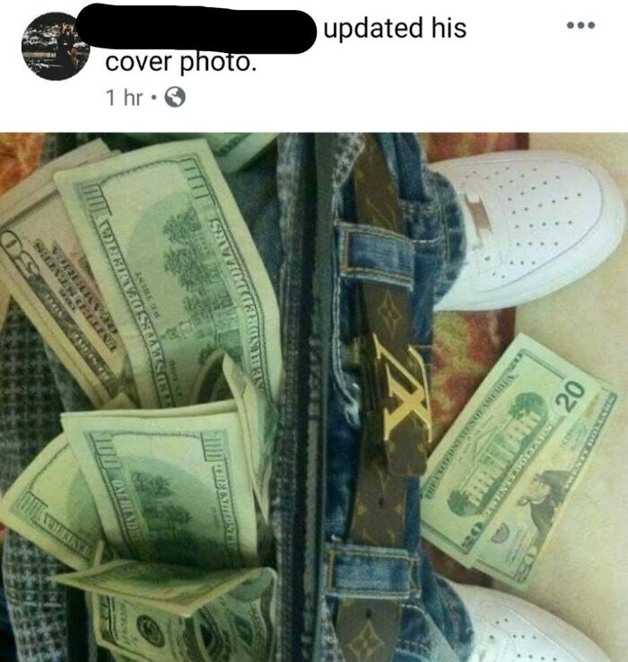 Stack of cash in pants pocket with luxury belt, highlighting rich people shamed for wealth display.