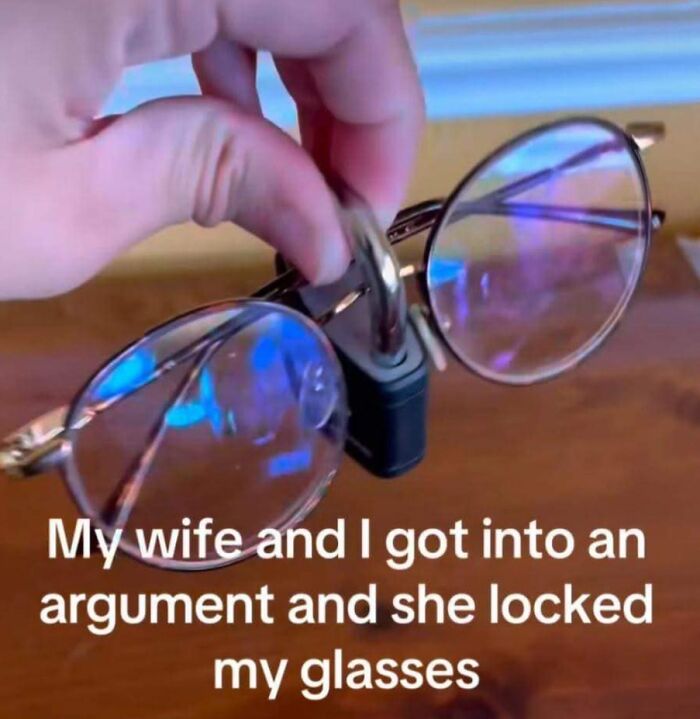 A hand holding glasses locked with a padlock, displaying sarcastic humor.