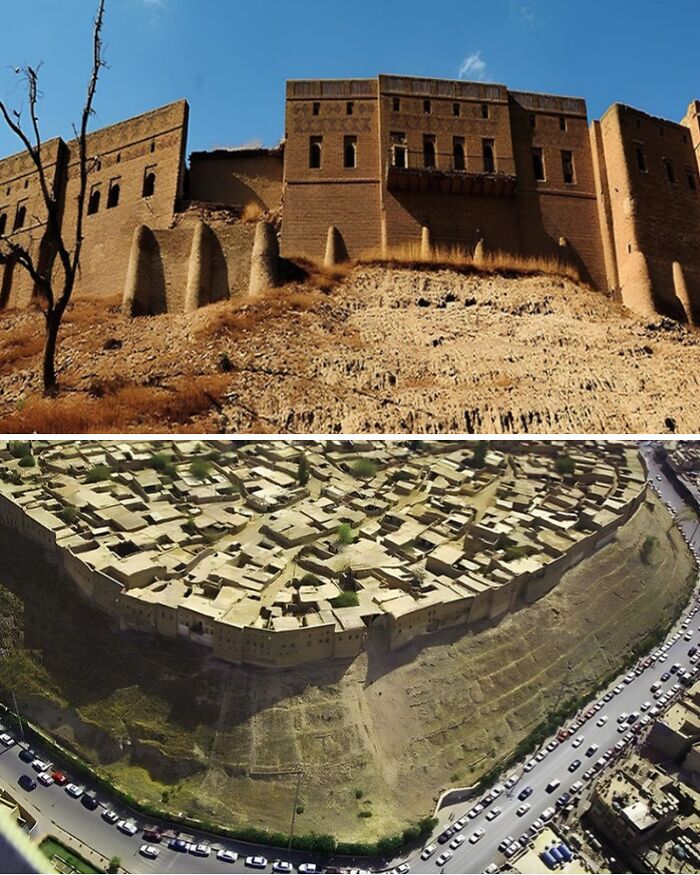 Ancient explorers discovered a well-preserved fortress overlooking a city with historic architecture, surrounded by a large wall.