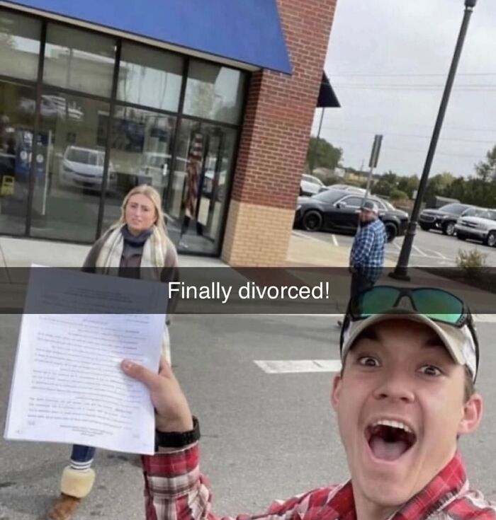 Excited man holding papers outside building, capturing a moment of sarcasm.