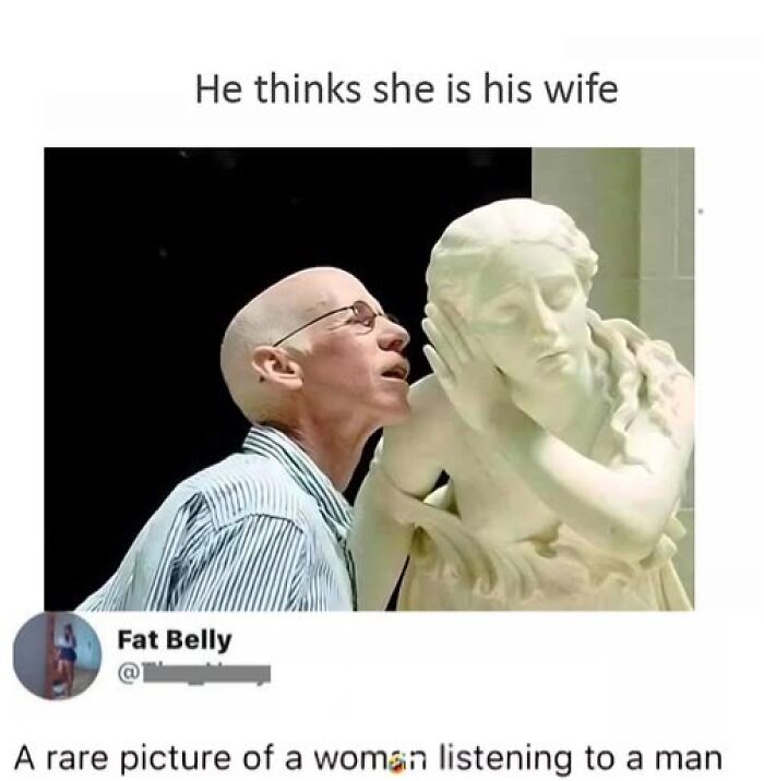 A man humorously whispers to a statue, adding a touch of sarcasm.