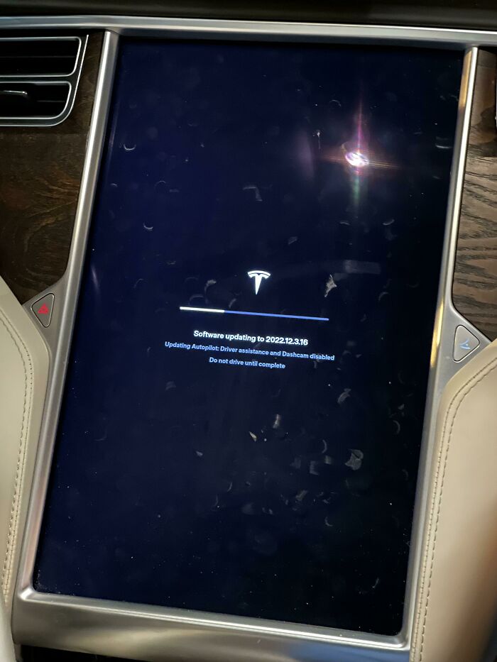 Tesla car display screen showing a software update in progress.