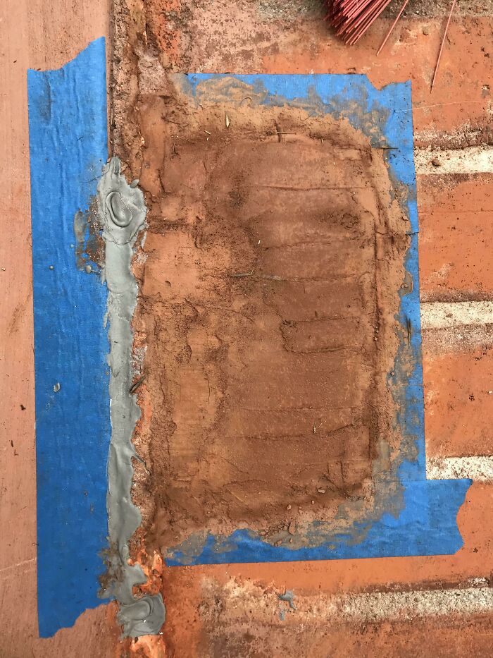 Messy construction patch job with blue tape on a concrete surface, illustrating worst in-laws' handiwork.