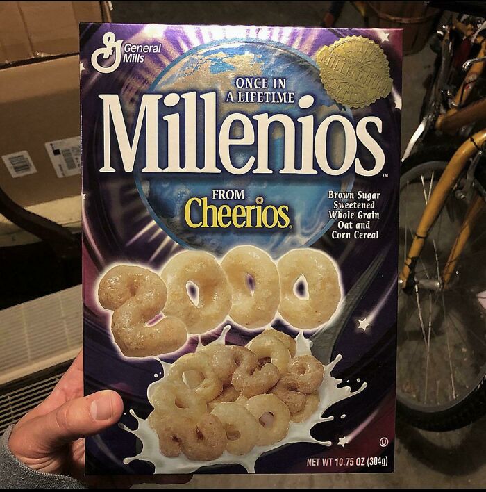 Hand holding vintage Millenios cereal box from Cheerios, a collectible 2000s item.